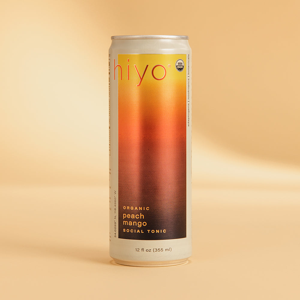 Tall aluminum can with "hiyo" branding and gradient label transitioning from yellow to orange to red, labeled "organic peach 