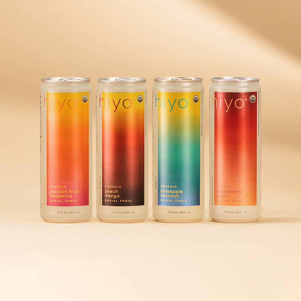 Four 12 fl oz cans of Hiyo organic social tonic in passion fruit tangerine, peach mango, pineapple coconut, and strawberry gu