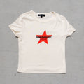 Cream baby tee with red star and "happy in your own" text graphic on chest.