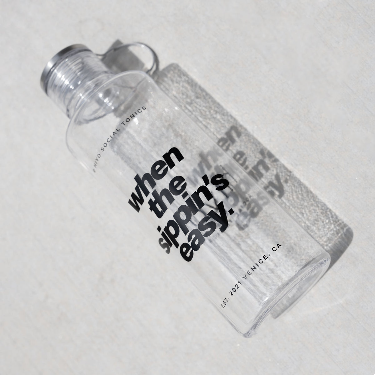 Clear plastic water bottle with threaded cap and pull-loop, printed with text reading "when the sippin's easy."